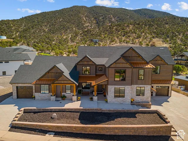 Modern exterior featuring a dark-toned roof, wood-finish siding, and light-toned stone accents