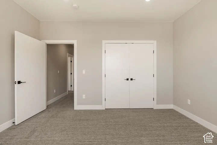 Recessed lighting, wall-to-wall carpeting, contemporary interior doors, and modern door hardware