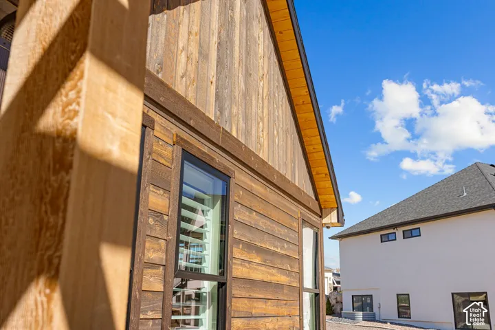 Wood-paneled exterior with natural wood trim and black-framed windows