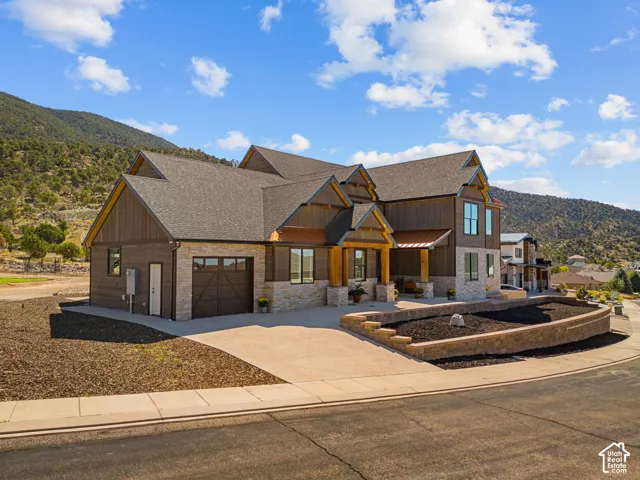 Multi-level architectural design featuring stone and wood siding