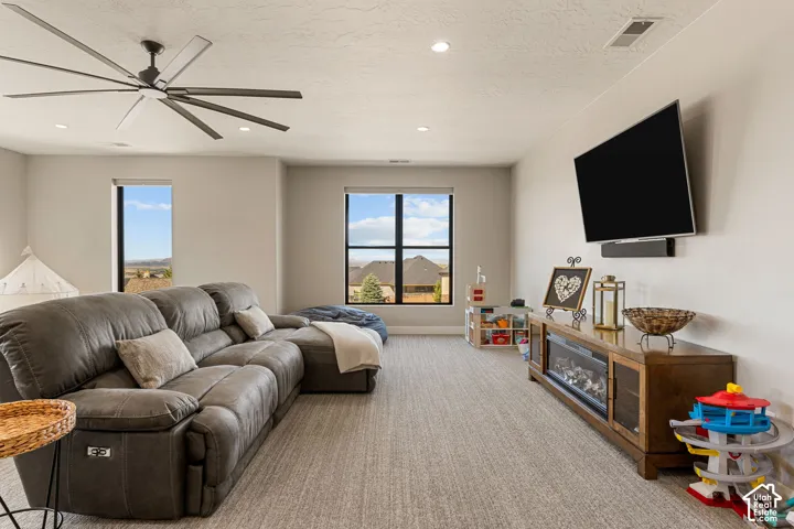 Recessed lighting, ceiling fan, two windows, wall-mounted television, built-in electric fireplace
