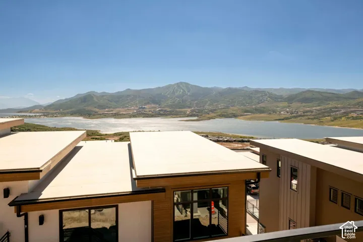 Modern residential architecture with a wood-finish exterior accent, flat roofline, and expansive windows