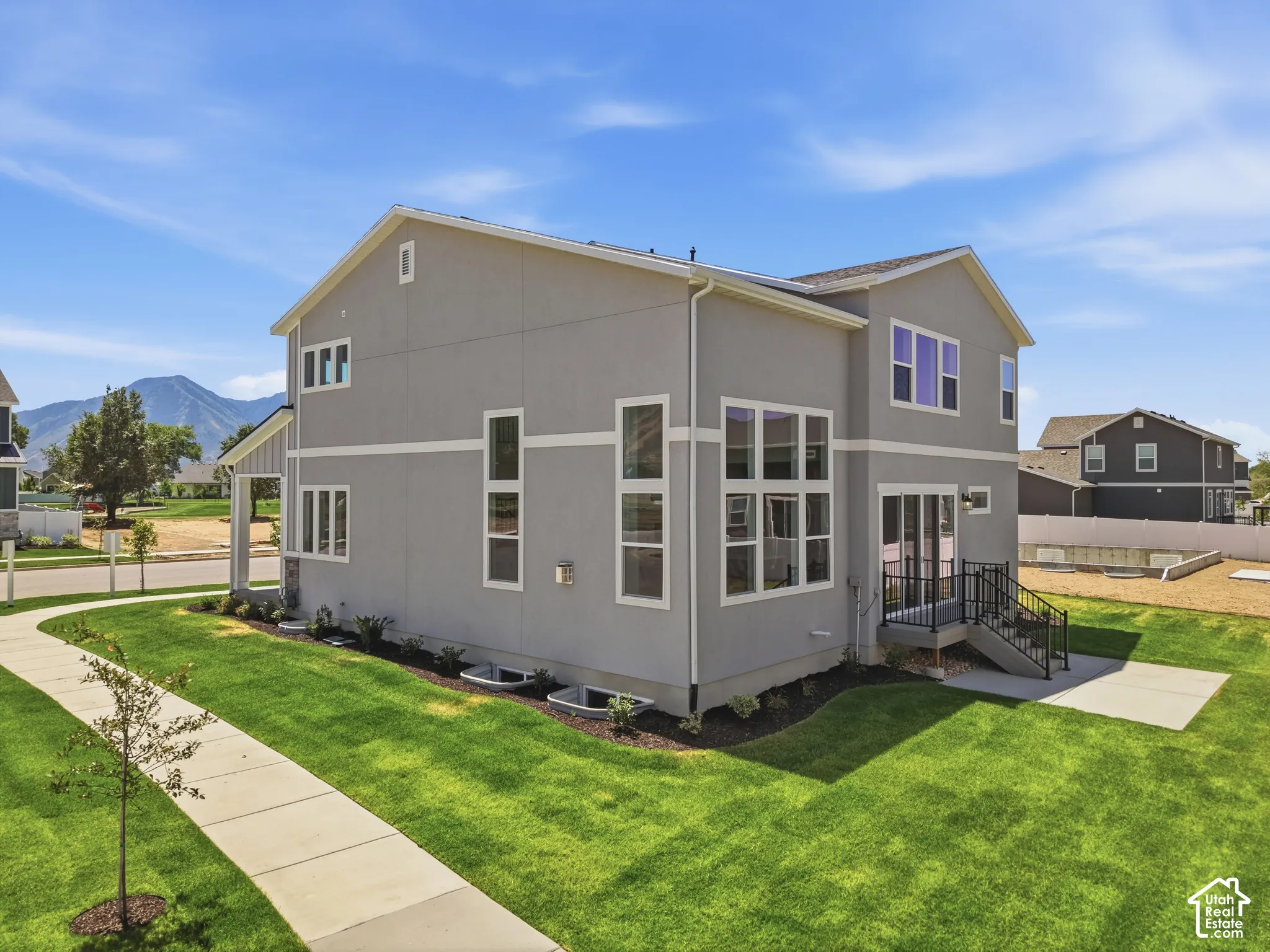 Modern two-story exterior with a stucco finish