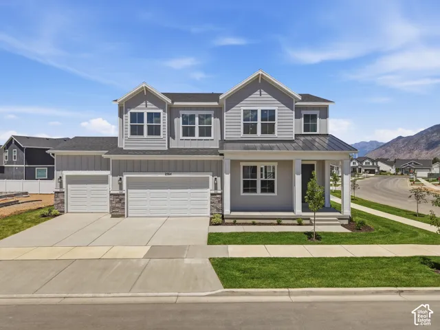 Contemporary two-story residence with gray siding and stone accents
