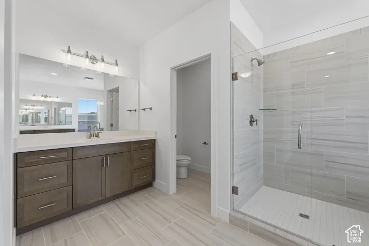 Expansive vanity with a countertop, undermount sink, and wood-finish cabinetry