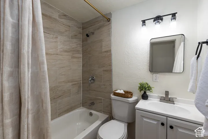 White vanity with integrated sink, brushed nickel faucet, and a black framed mirror