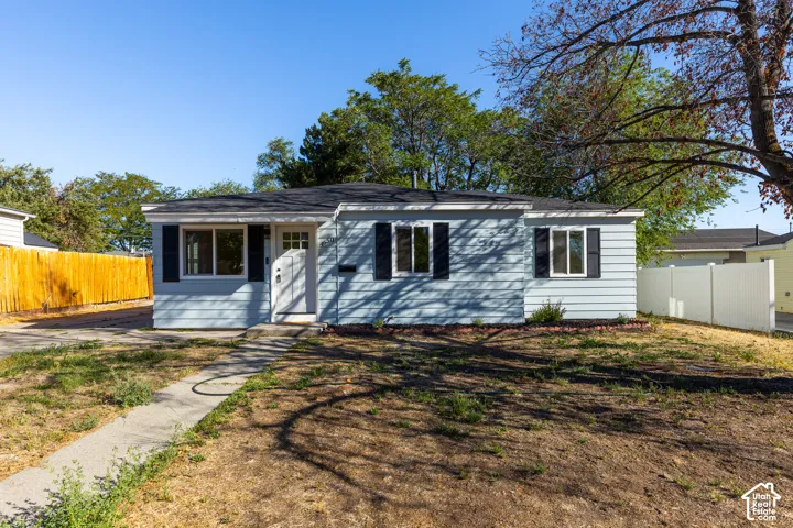 Light blue siding exterior with black window shutters and white trim