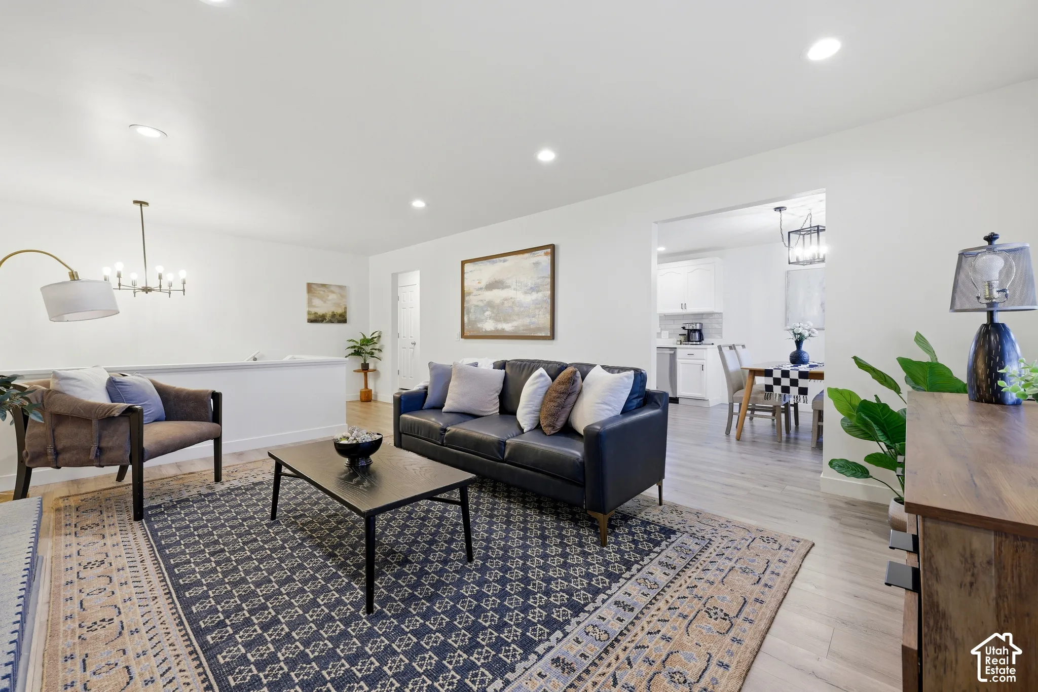 Bright living area featuring wood-finish flooring, recessed lighting, and a white half-wall partition