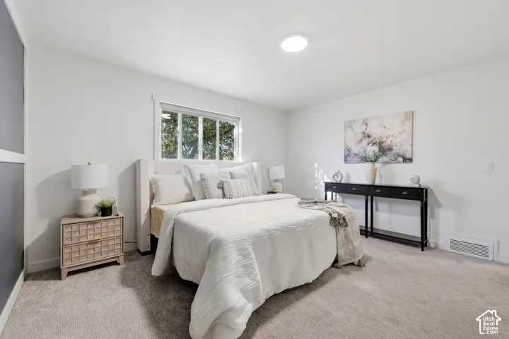 Carpeted flooring, white walls, recessed lighting, and a multi-pane window
