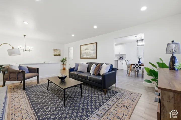 Bright living area featuring wood-finish flooring, recessed lighting, and a white half-wall partition