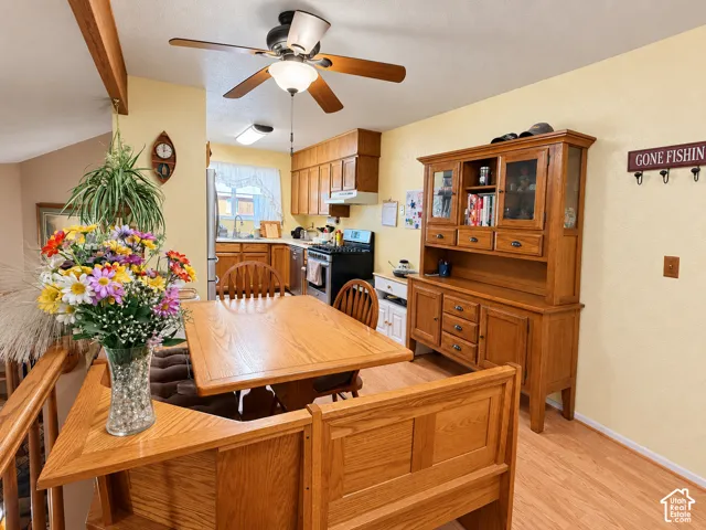 Kitchen area featuring wood-finish cabinetry, stainless steel refrigerator, and built-in dishwasher
