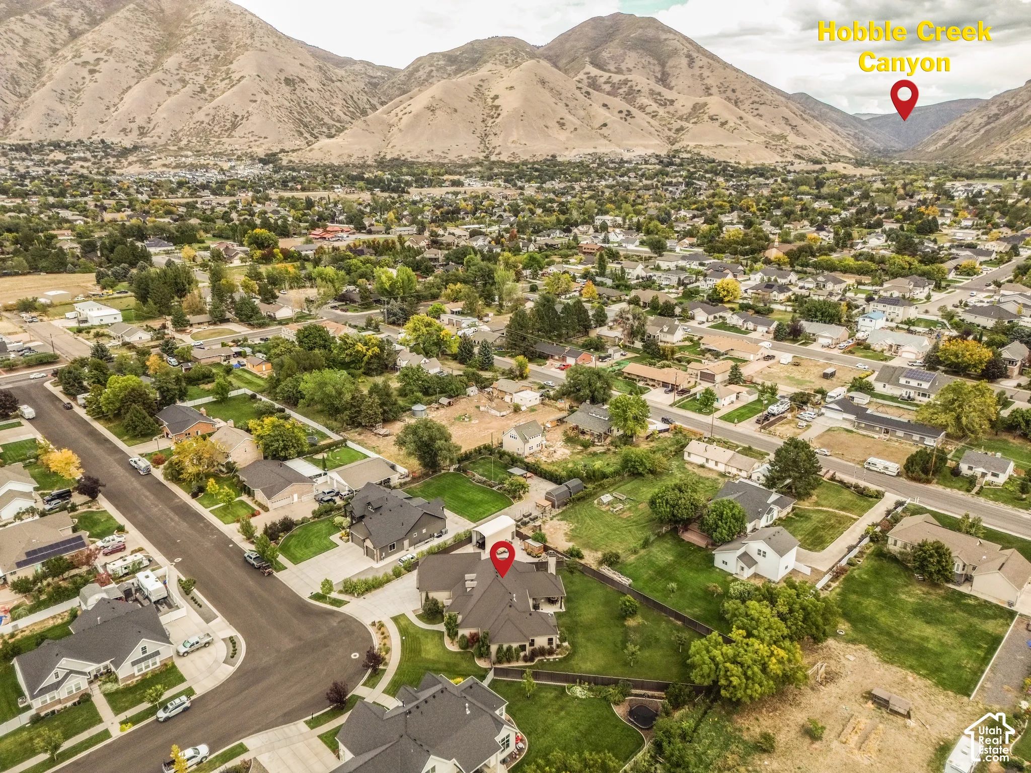 Aerial perspective showcasing the residential area with mountainous terrain in the background