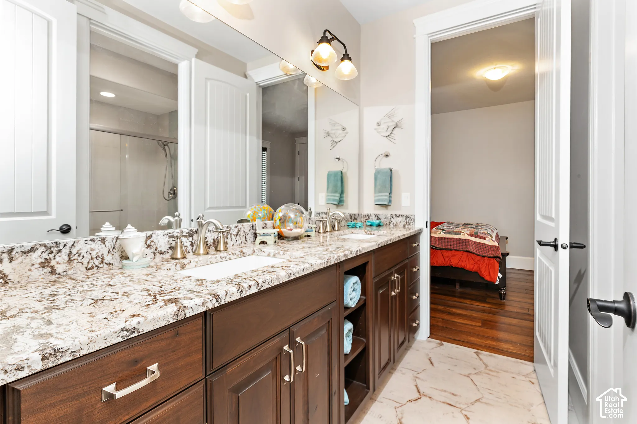 Dual vanity with stone-finish countertop, undermount sinks, and brushed nickel fixtures