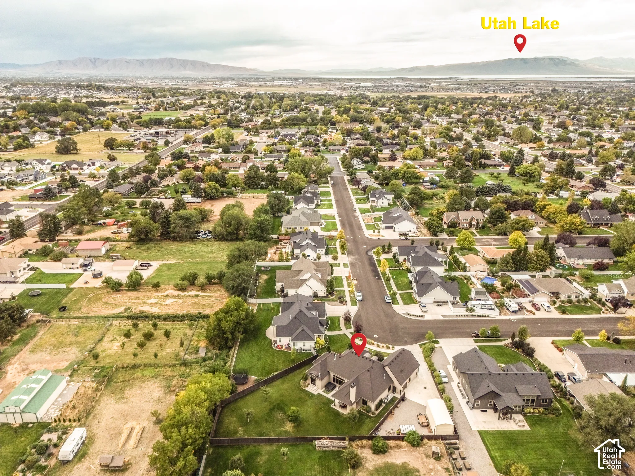 Aerial perspective showcasing a residential neighborhood with distant mountains and Utah Lake