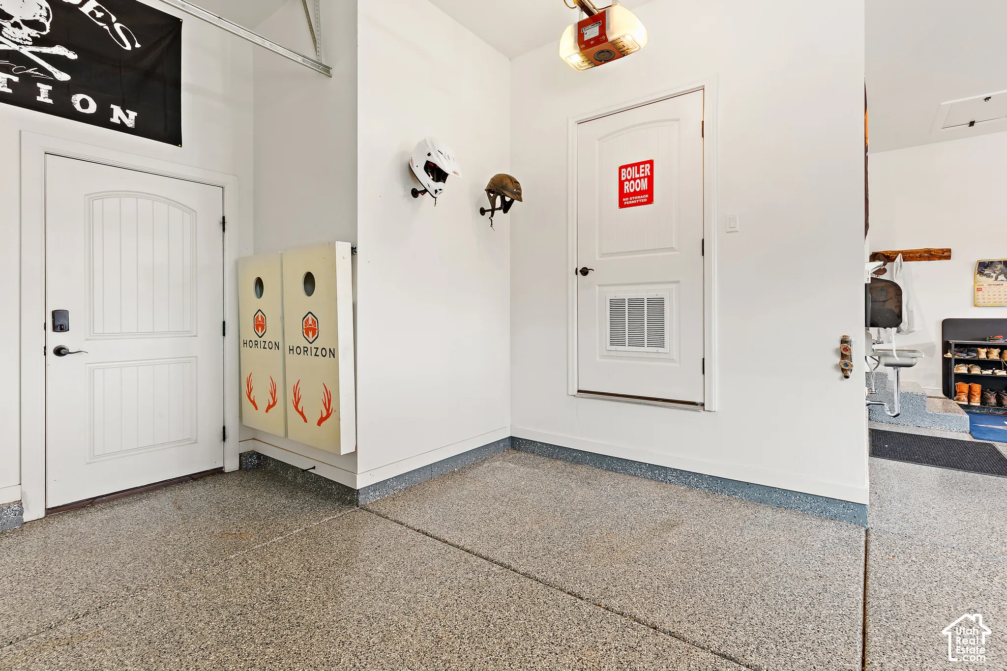 Epoxy-coated flooring, white interior doors, and a built-in garage door opener