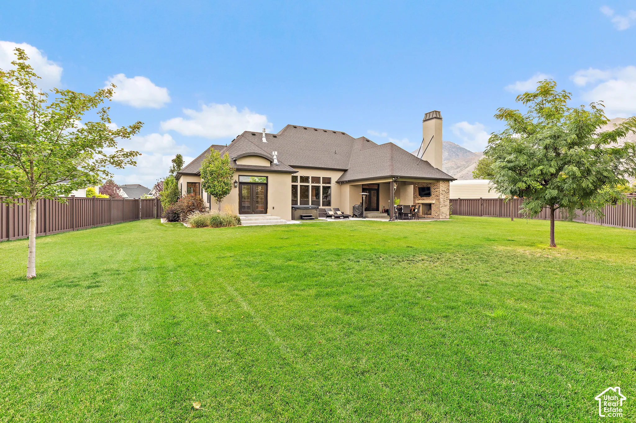 Expansive fenced backyard with a large lawn