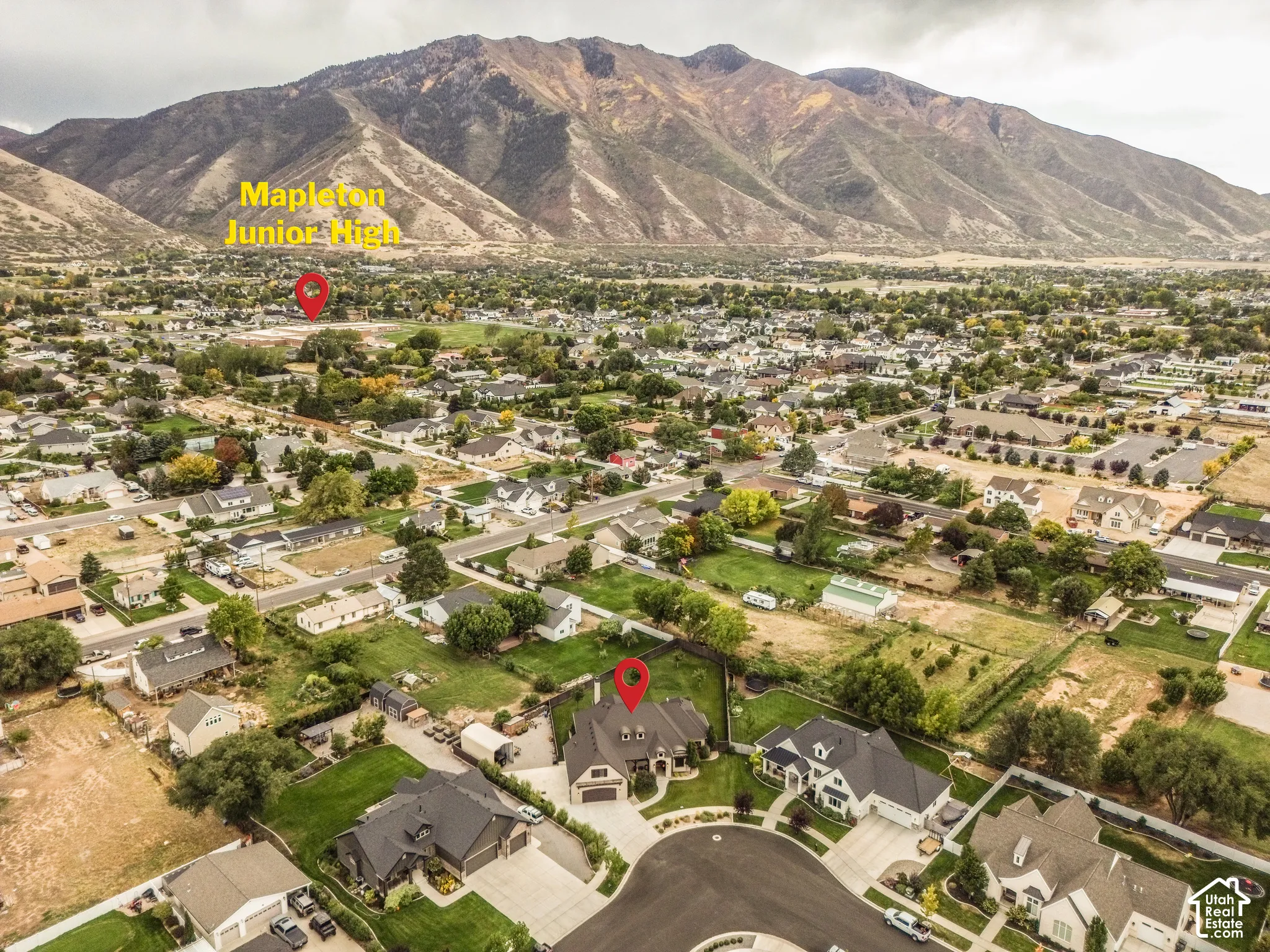 Residential property situated on a cul-de-sac with a paved driveway and an attached garage