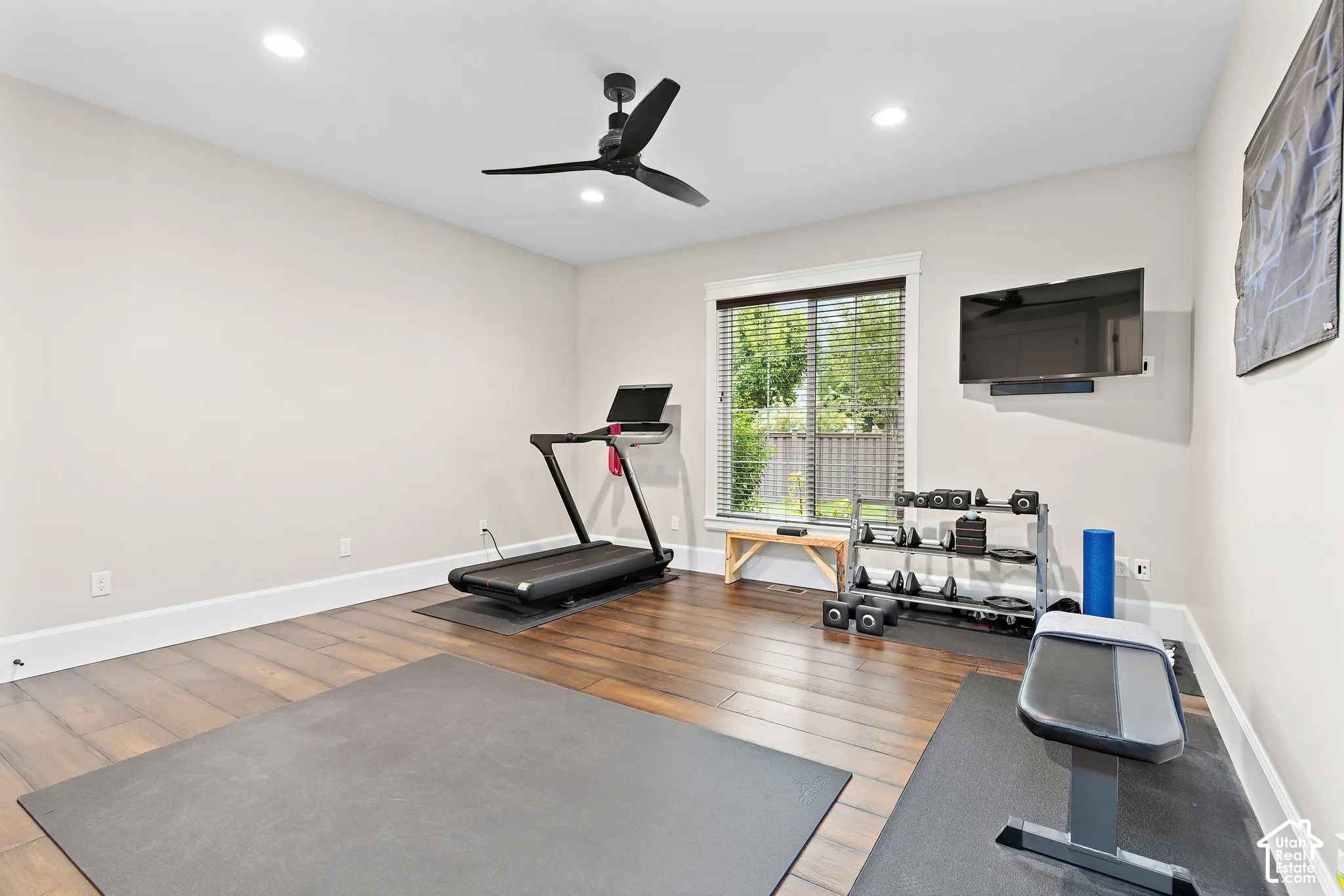 Wood-finish flooring, recessed lighting, and a ceiling fan