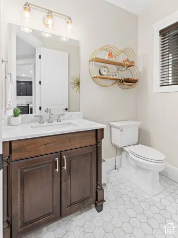 Dark wood-finish vanity with a white countertop and undermount sink