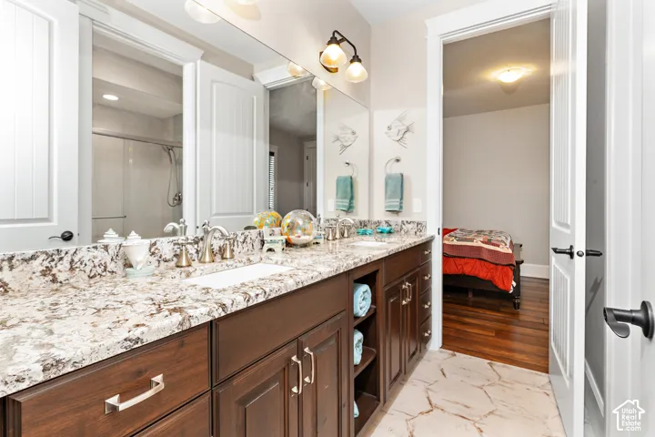 Dual vanity with stone-finish countertop, undermount sinks, and brushed nickel fixtures