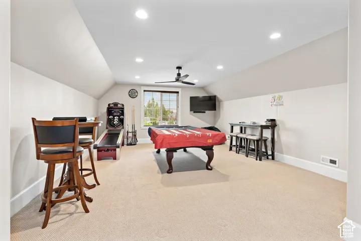 Spacious bonus room featuring vaulted ceilings, recessed lighting, carpet flooring, a ceiling fan, and a double window