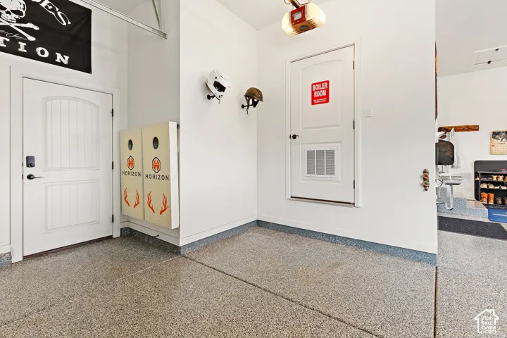 Epoxy-coated flooring, white interior doors, and a built-in garage door opener