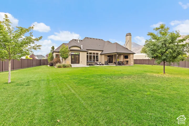 Expansive fenced backyard with a large lawn