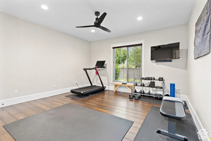 Wood-finish flooring, recessed lighting, and a ceiling fan