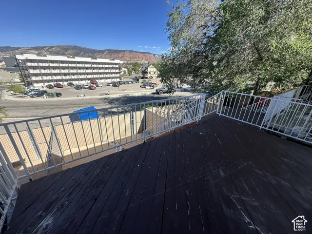 Spacious outdoor deck with painted wood flooring and white metal railings