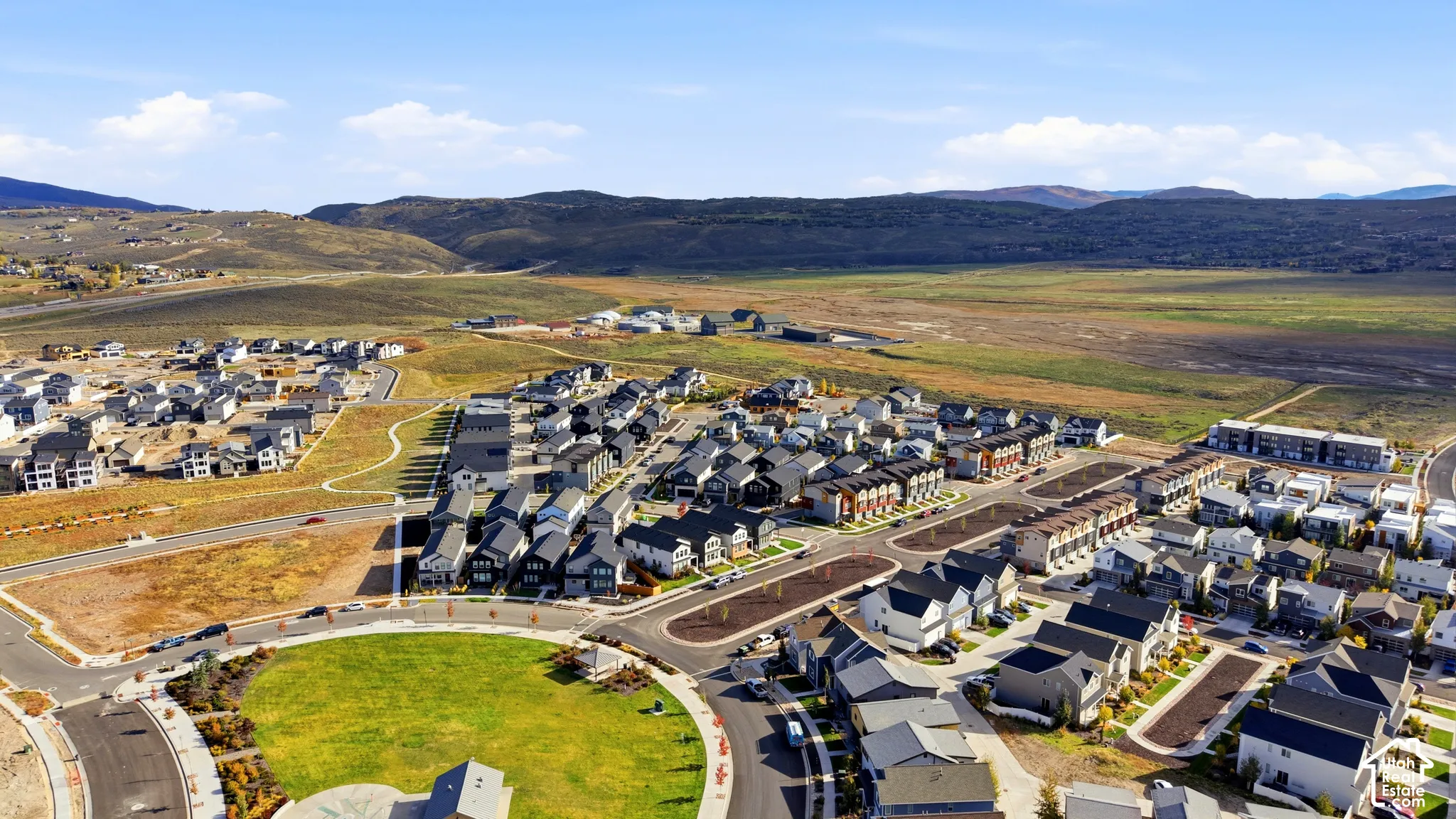 Residential development with varied architectural styles, green spaces, and paved roads