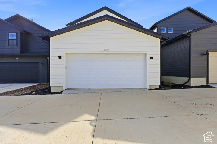 White horizontal siding exterior with a two-car garage