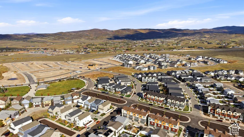 Expansive community featuring diverse residential architecture, developed streets, and surrounding natural landscape