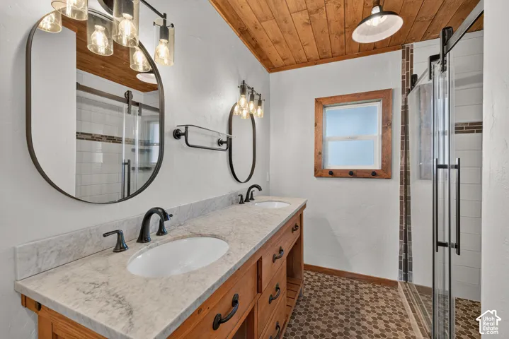 Dual vanity with undermount sinks, stone countertop, and wood-finish cabinetry