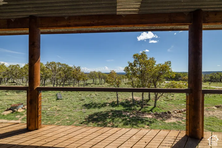 Expansive wooden deck with exposed beam construction and corrugated metal roofing