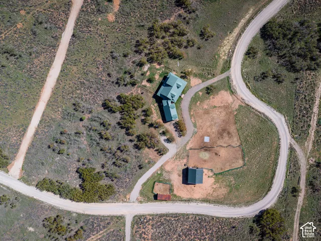 Property featuring a main residence, an additional auxiliary building, and extensive surrounding land with established roadways