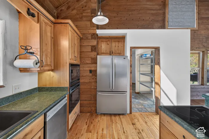 Warm wood-panel walls, wood-finish flooring, and light wood cabinetry