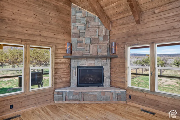 Wood-paneled walls and ceiling with exposed wood beams