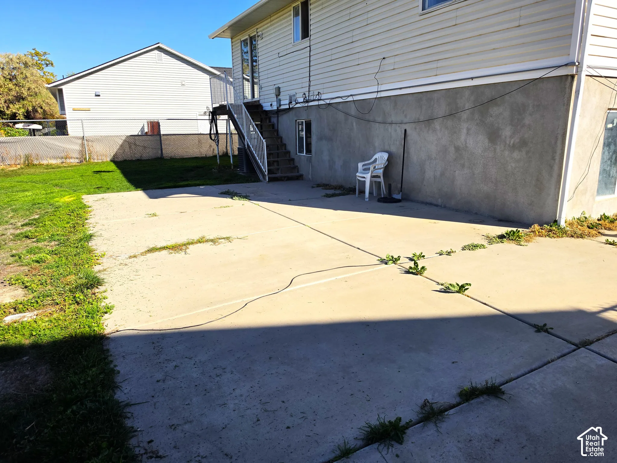 Concrete patio with exterior staircase access