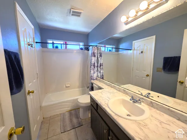 Bathroom featuring a vanity with a white oval sink, chrome faucet, and a full-width mirror