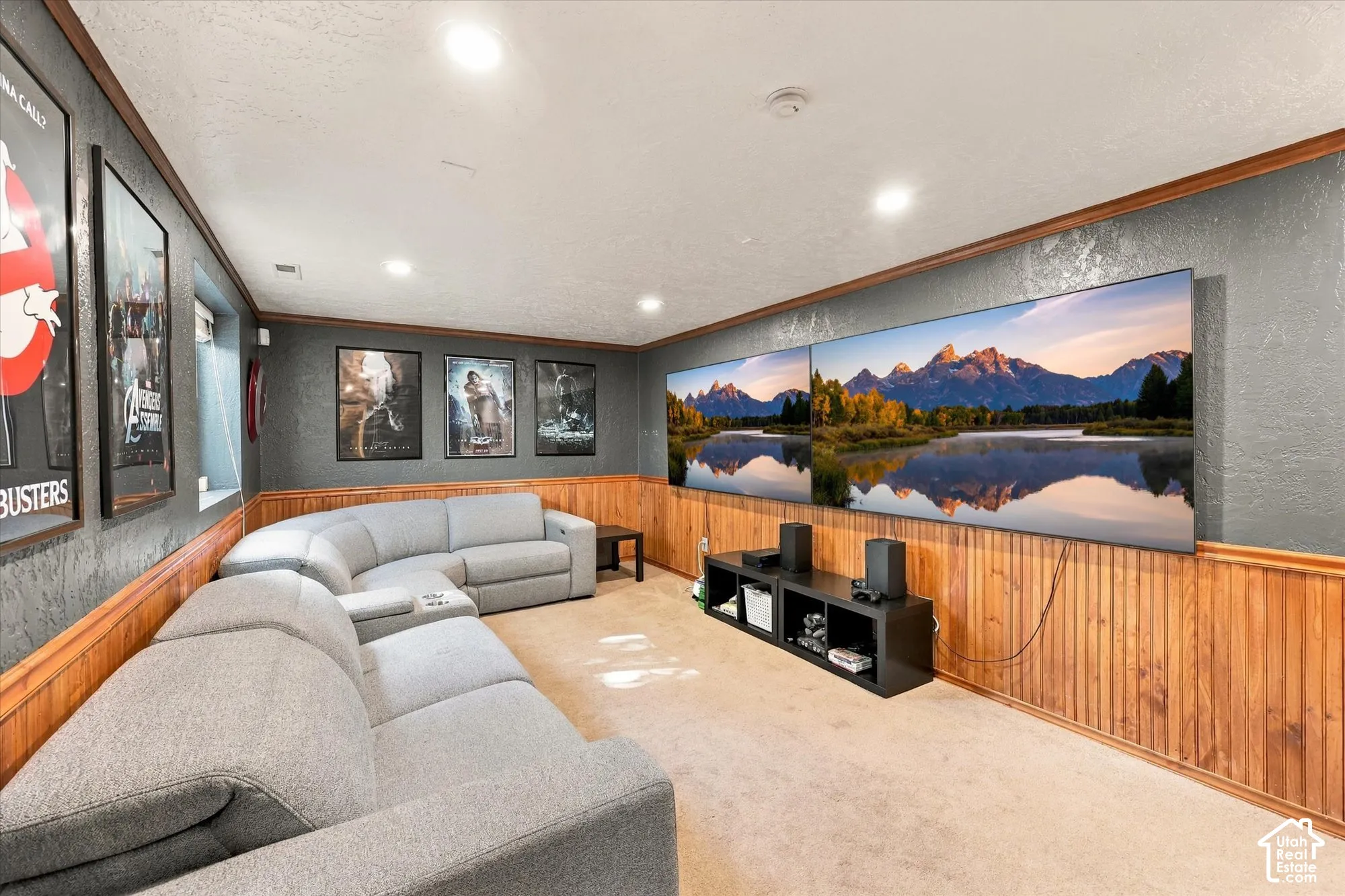 Recessed lighting illuminates the textured wall finish and wood-paneled wainscoting