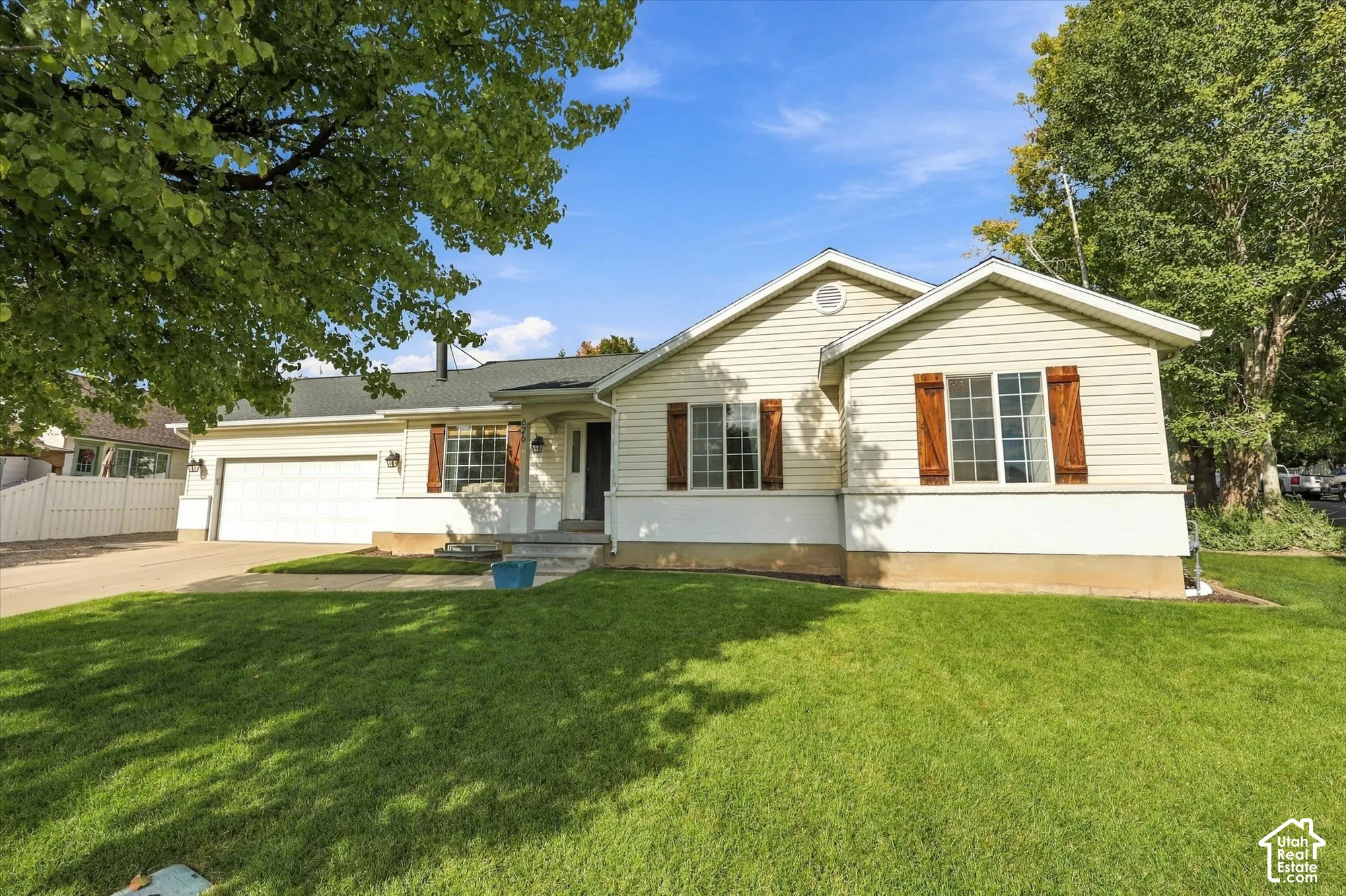 Cream-colored siding exterior with dark wood window shutters