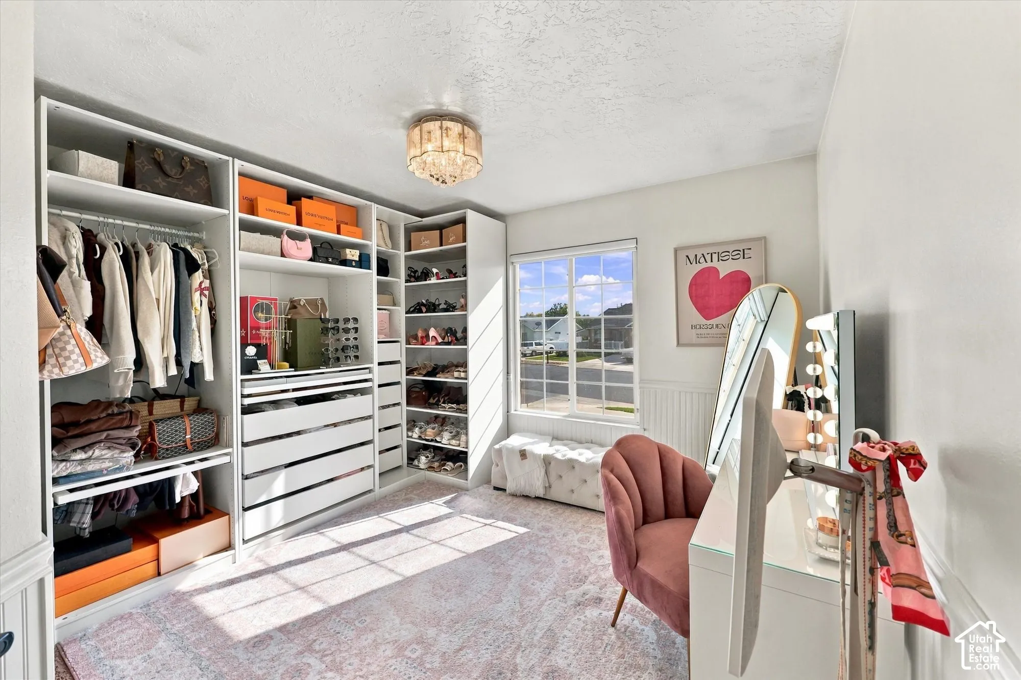 Built-in custom closet system with extensive shelving, hanging rods, and drawer storage