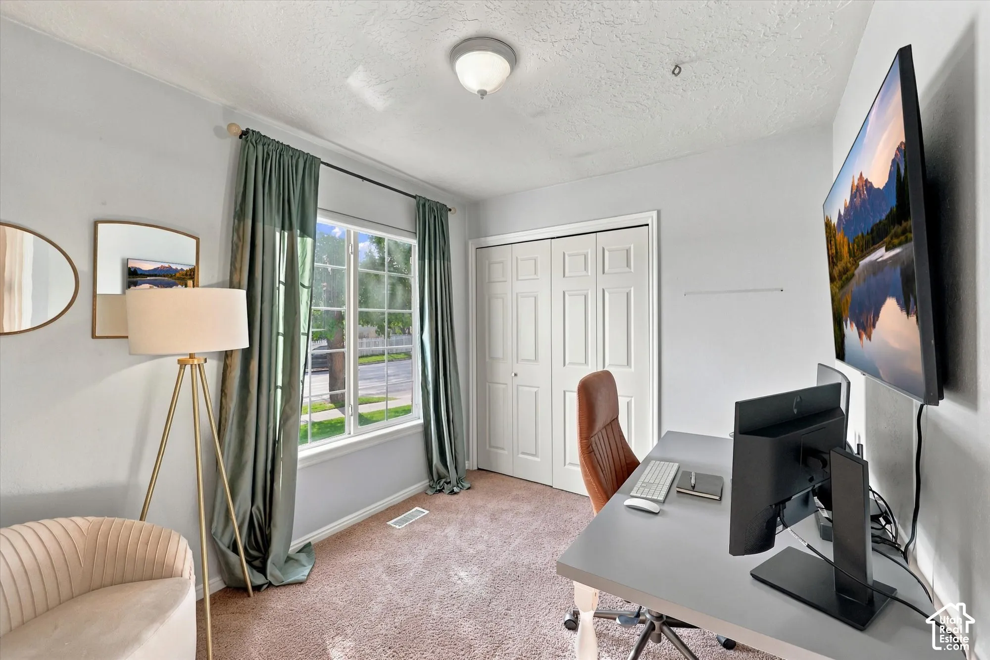 Window with exterior views, carpeted flooring, and a flush mount light fixture