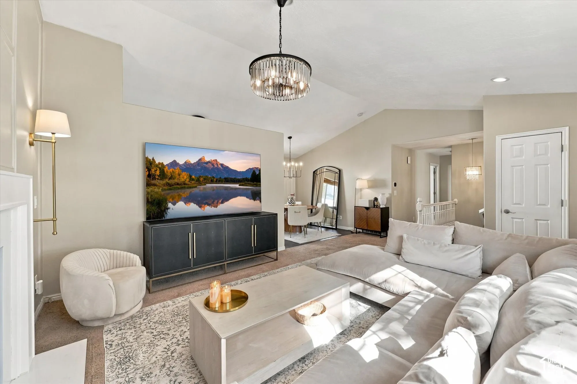 Vaulted ceiling, recessed lighting, chandelier, fireplace with mantel, built-in media console