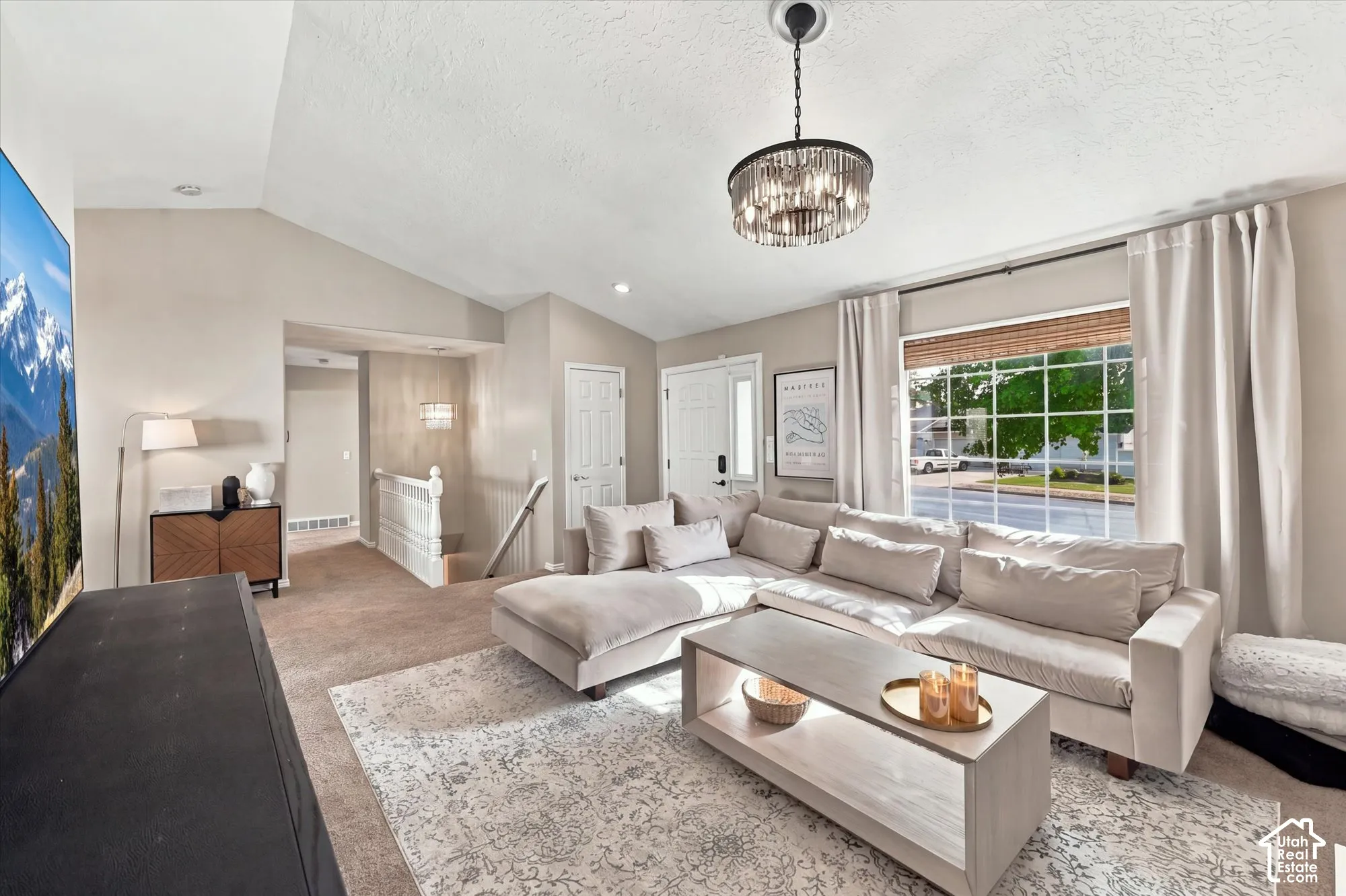 Vaulted ceilings with a contemporary chandelier and recessed lighting