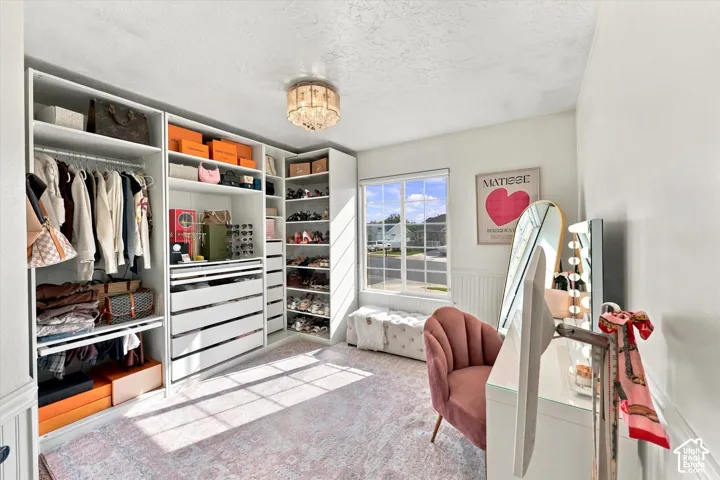 Built-in custom closet system with extensive shelving, hanging rods, and drawer storage