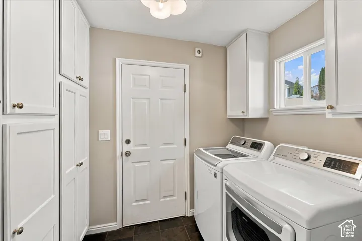 Ample built-in white cabinetry, paneled door, ceiling-mounted light fixture, and a window providing natural illumination