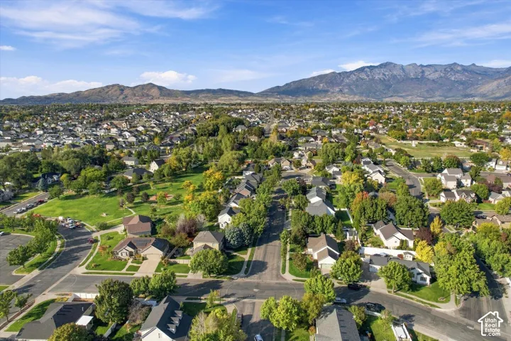 Residential neighborhood with mature trees and mountain backdrops