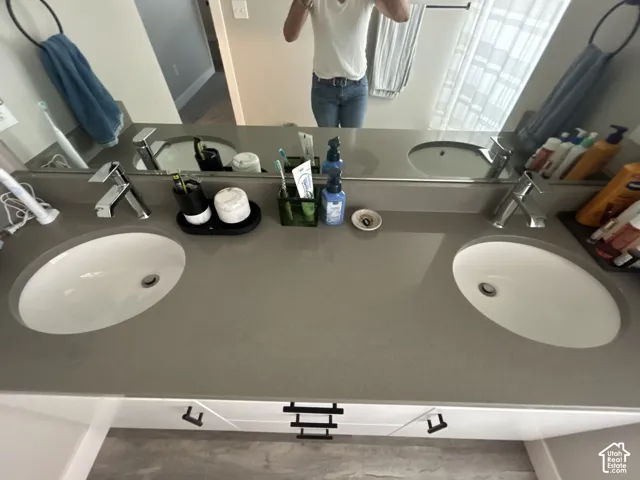 Dual undermount sinks with chrome faucets, set within a wide countertop