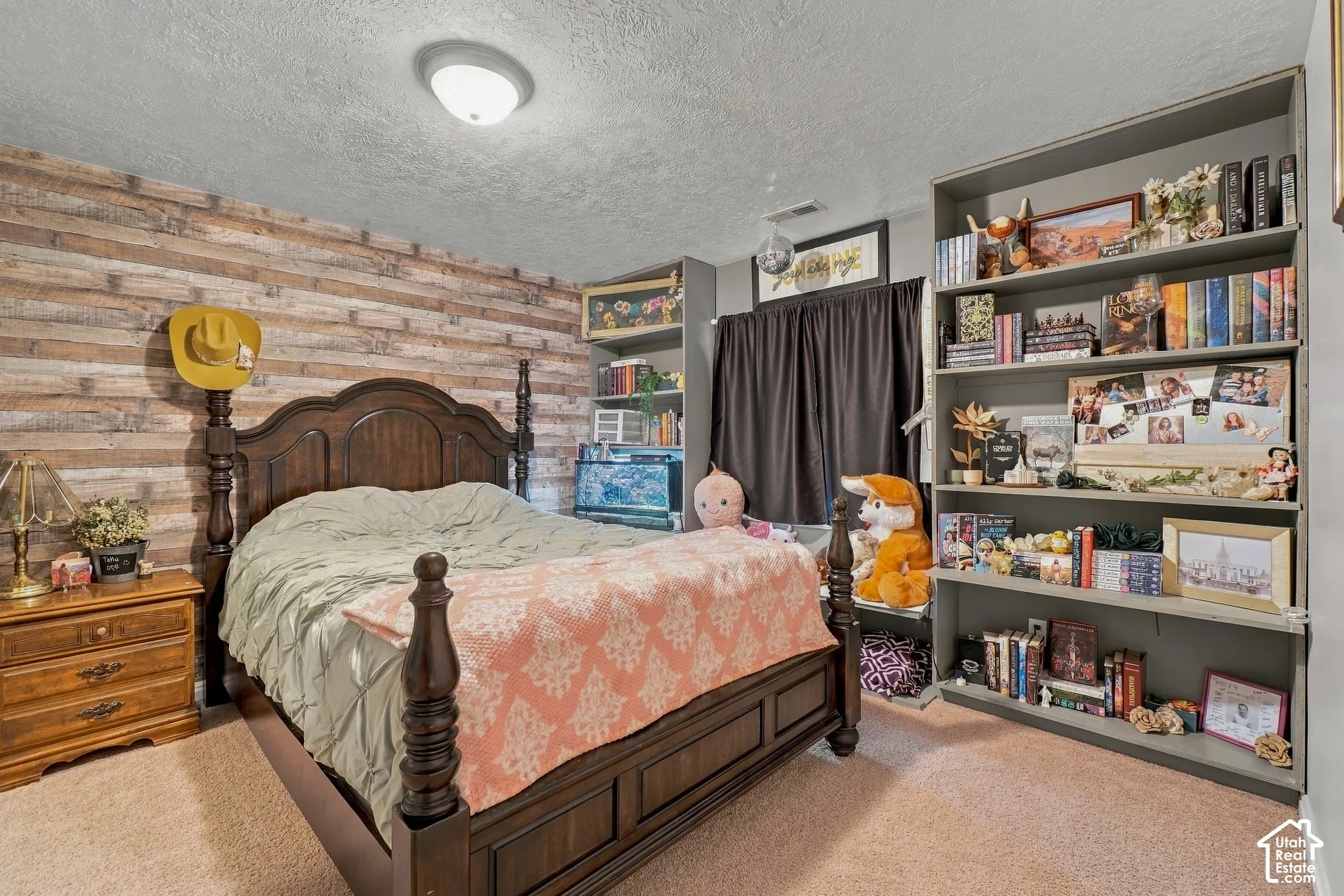 Textured wood-finish accent wall, built-in shelving, flush-mount ceiling light